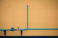 Minimalism style, Blue water tube with valve on the wall. Royalty Free Stock Photo