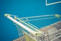 Minimalism style, Shopping cart and blue wall. Royalty Free Stock Photo