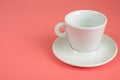 Minimalism white empty Cup with saucer on pink background