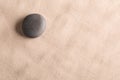 Minimalism zen background with black stone in sand Royalty Free Stock Photo