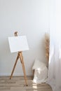 Minimalist aesthetic artist home workspase, easel with abstract plaster design canvas near window with sunlight, home