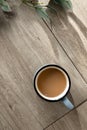 Minimalist aesthetic morning coffee break, hot coffee drink cup and green plants with sun light shadows on neutral beige Royalty Free Stock Photo