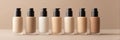 Neutral Foundation Bottles Arranged on a Minimalist Surface With a Blank Left Margin for a Clean Aesthetic in a Beauty Royalty Free Stock Photo