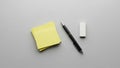 Minimalist arrangement on a gray surface features a stack of yellow sticky Royalty Free Stock Photo