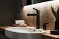 Minimalist bathroom close up with sleek matte black faucet