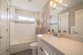 Minimalist bathroom interior with built in bathtub toilet and vanity area Royalty Free Stock Photo