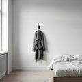 Minimalist Bedroom with Hanging Coat and Bed Royalty Free Stock Photo