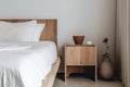 minimalist bedroom with natural wood nightstand and plush white sheets
