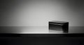 Minimalist Black Box on Reflective Surface with Spotlight Royalty Free Stock Photo