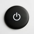 Minimalist black power button with a white circular icon on a glossy surface Royalty Free Stock Photo