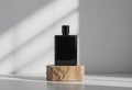Minimalist Black Rectangular Perfume Bottle on Natural Stone Base with Gradient Background Royalty Free Stock Photo