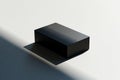Minimalist black rectangular prism object casting shadow on a plain white background surface Royalty Free Stock Photo