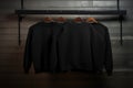 Minimalist Black Sweatshirts on Wooden Hangers