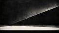 A minimalist black and white composition featuring a triangular shape and a white surface. Royalty Free Stock Photo