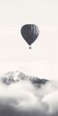 Minimalist Black And White Hot Air Balloon Above Clouds With Mountain Scene Royalty Free Stock Photo