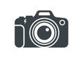 A minimalist black and white icon of a camera. The design emphasizes the lens, with concentric Royalty Free Stock Photo