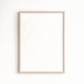 Minimalist Blank Frame on Neutral Wall in Natural Light Royalty Free Stock Photo