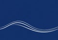 A minimalist blue background with a smooth wavy design composed of three parallel white lines. The Royalty Free Stock Photo