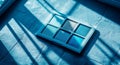 On a minimalist blue concrete surface, a teal eyeshadow compact is showcased under soft natural light, with ample copy space Royalty Free Stock Photo