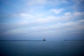 Minimalist blue lake view with distant pier Royalty Free Stock Photo