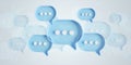 Minimalist blue and white speech bubbles talk icons floating over grey background. Modern conversation or social media messages Royalty Free Stock Photo