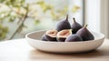 A minimalist bowl of fresh figs placed on a clean white ceramic tray Royalty Free Stock Photo