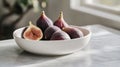 A minimalist bowl of fresh figs placed on a clean white ceramic tray Royalty Free Stock Photo