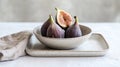 A minimalist bowl of fresh figs placed on a clean white ceramic tray Royalty Free Stock Photo