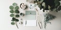Minimalist branding, business card mockup with a stack of cards in a small bowl, boho necklace and eucalyptus twigs Royalty Free Stock Photo