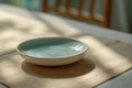 Minimalist ceramic bowl on light linen placemat with soft lighting Royalty Free Stock Photo