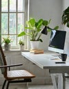 Minimalist clean white desk with computer, plant and cup of coffee. Royalty Free Stock Photo