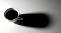 Minimalist Coffee Cup with Dramatic Shadow on Gray Background Royalty Free Stock Photo