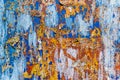 Minimalist colourful textured background of old and rusted whit, blue, brown and orange paing on metallic surface, in direct sun