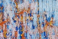 Minimalist colourful textured background of old and rusted whit, blue, brown and orange paing on metallic surface, in direct sun