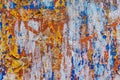 Minimalist colourful textured background of old and rusted whit, blue, brown and orange paing on metallic surface, in direct sun