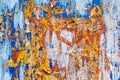 Minimalist colourful textured background of old and rusted whit, blue, brown and orange paing on metallic surface, in direct sun