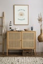 Minimalist composition of cozy and domestic space of living room with rattan commode, mock up poster frame, decoration, vase, Royalty Free Stock Photo