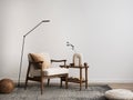 Minimalist composition of elegant living room space with white boucle armchair, ball, carpet, coffee table, lamp, decoration, vase