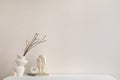 Minimalist composition of elegant and outstanding space with copy space, vase with dried flowers, beige sculpture and personal