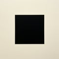 A minimalist composition featuring a large black square centered on a plain, light beig Royalty Free Stock Photo