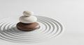 Stacked Zen Stones On Raked Sand With Concentric Circles On White Background rocks balance Royalty Free Stock Photo