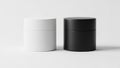 Two cylindrical containers, one white and one black, standing side by side. isolated on white background Royalty Free Stock Photo