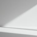 A minimalist composition featuring a white surface with diagonal shadows. The lighti Royalty Free Stock Photo