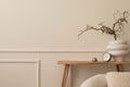 Minimalist composition of living room interior with copy space, wooden bench, white vase with branch, clock, silver ball, beige Royalty Free Stock Photo