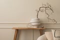 Minimalist composition of living room interior with copy space, wooden bench, white vase with branch, sculpture, silver ball, Royalty Free Stock Photo