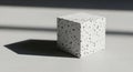 Minimalist composition of a textured cube casting a dramatic shadow in sunlight Royalty Free Stock Photo