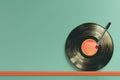 Minimalist concept with vinyl record and needle on green background, invoking a retro music theme Royalty Free Stock Photo