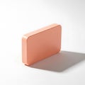Minimalist copper colored rectangular object on white surface isolated on white background Royalty Free Stock Photo