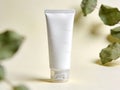 Minimalist cosmetic tube packaging photographed in a clean studio setting with soft lighting and natural leaf elements, ideal for Royalty Free Stock Photo