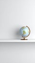 Minimalist 3D rendered Earth globe on a white shelf clean wall background ample copy space for text Royalty Free Stock Photo